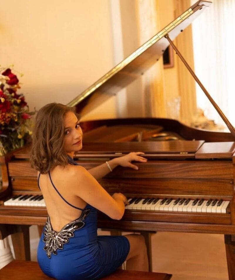 Elegant 1 Grand Party Pop pianist in a blue gown delivering high-energy entertainment on a single grand piano.